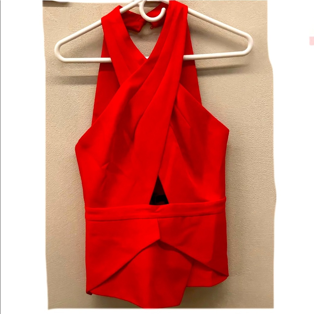 Sleeveless halter red top with zipper closure on the back and buttons at neck.
